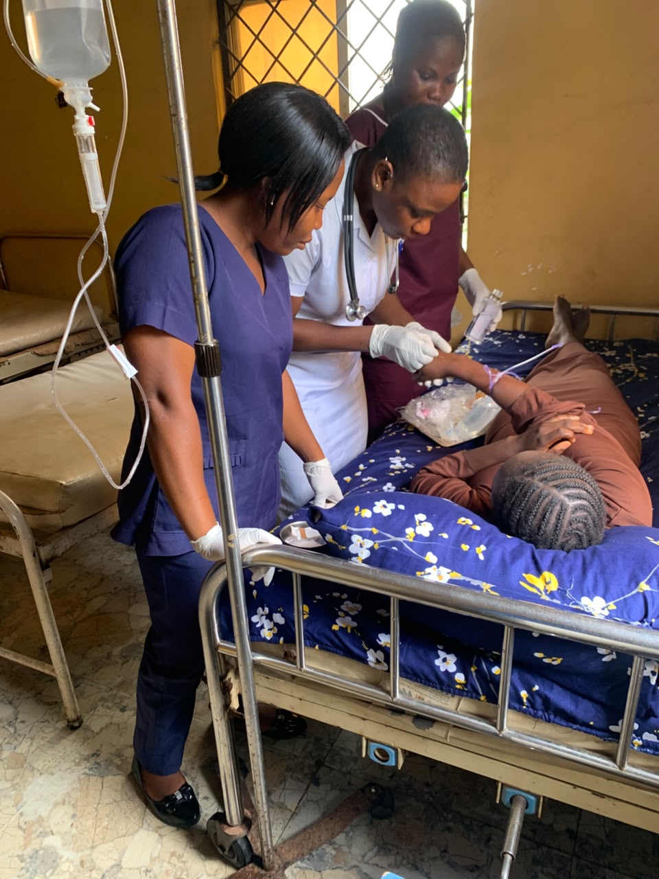 Nurses attending to patient and setting IV line